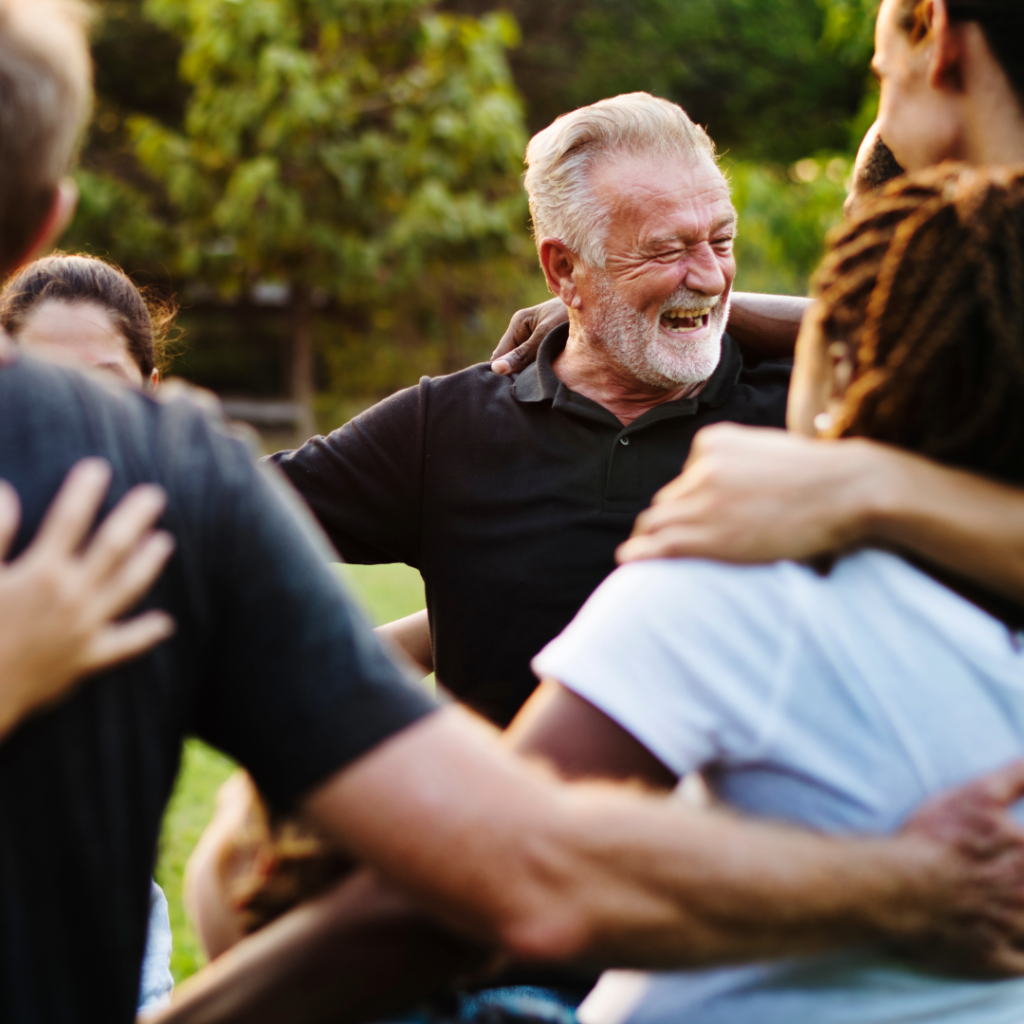Diverse group of individuals sitting in a circle, engaging in a heartfelt discussion and supporting one another, symbolizing the healing power of community